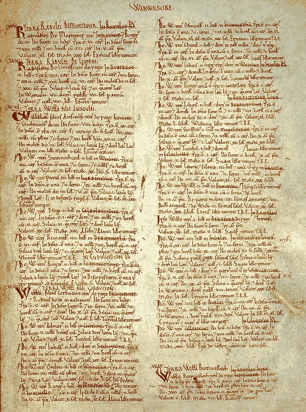 A parchment manuscript page filled with two columns of closely written text in brown ink and red headings.